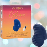The CalExotics Cashmere Dual Finger Massager in dark blue is pictured beside its box, which lists features: liquid silicone, 10 speeds, waterproof (IPX7), and USB rechargeable.